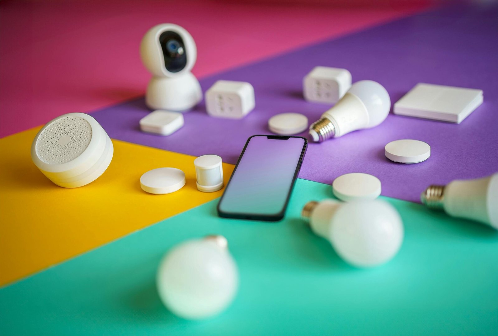 Smart devices arranged on colorful background showcasing modern technology options.